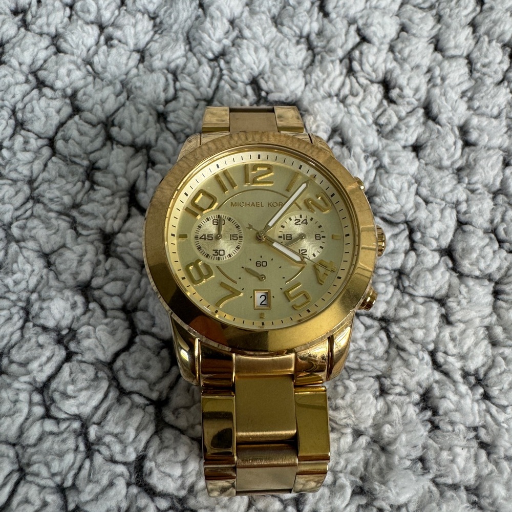 Gold women’s Michael Kors watch